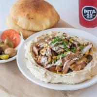 Hummus Shawarma (Halal) · Hummus with chicken shawarma on top, tahini sauce, drops of Amba and fresh parsley. Our chic...