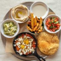 Shakshuka Plate 🌶  · A poached egg slow cooked in a savory sauce of roasted bell peppers and tomatoes, sprinkled ...