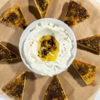 Labane (House-Made) · Strained yogurt topped with olive oil and served with a toasted za'atar spiced pita bread.