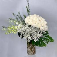 Flow Of Time · White Roses, Baby's Breath, Dendrobium Orchids, Eucalyptus, Monstera Leaves, Assorted greens...
