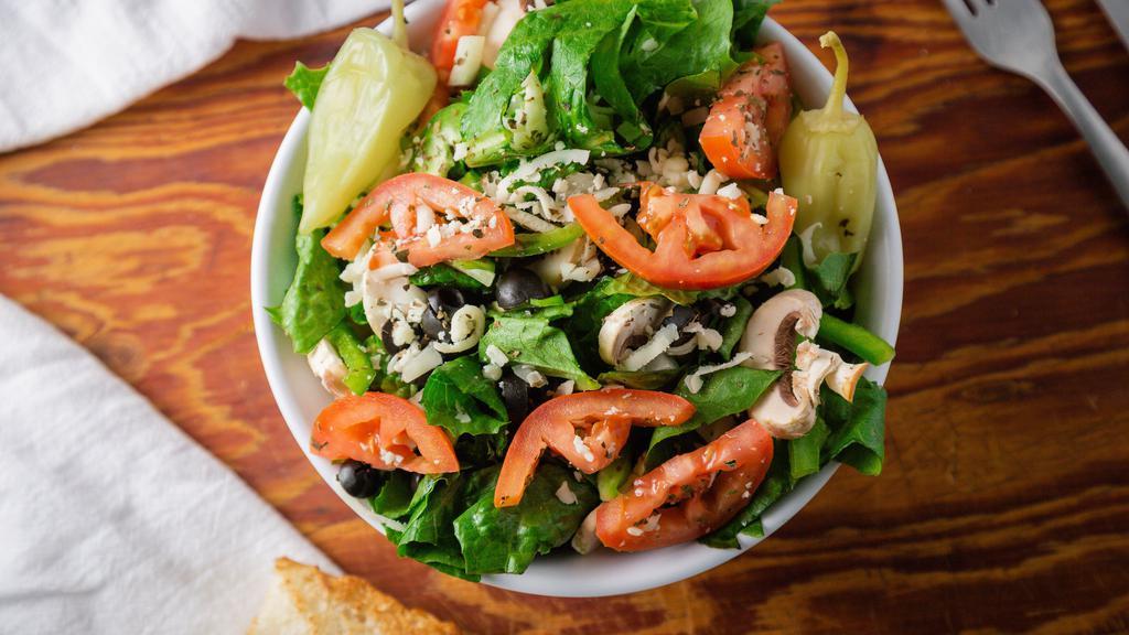 Garden Salad (Large) · Romaine lettuce, onions, mushroom, black olives, tomatoes, pepperoncini, mozzarella cheese, a pinch of basil, and your choice of dressing (on the side).