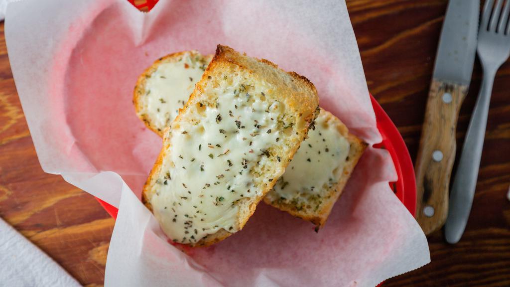 Garlic Bread (12') · Torpedo roll split in half, basted with garlic butter, and baked in our brick oven.