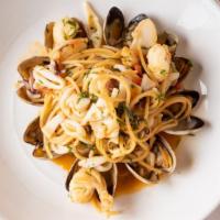 Scoglio · Spaghetti with calamari, shrimp, scallops, mussels and clams in a light spicy tomato sauce.