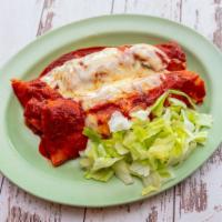 Enchiladas · Two enchiladas filled with your choice of meat smothered with our delicious red sauce, shred...