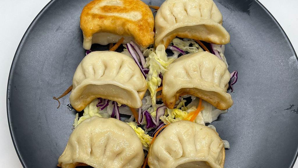 Pot Stickers (6) · Pan fried dumpling filled with chicken and cabbage.