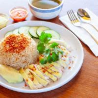 Hainan Chicken Rice · Poached organic chicken, Hainan rice, cucumber, crushed garlic, cilantro, ginger chili sauce.
