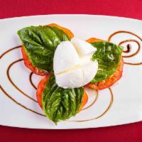 Caprese · Imported bufala mozzarella and heirloom tomatoes with basil and extra virgin olive oil.