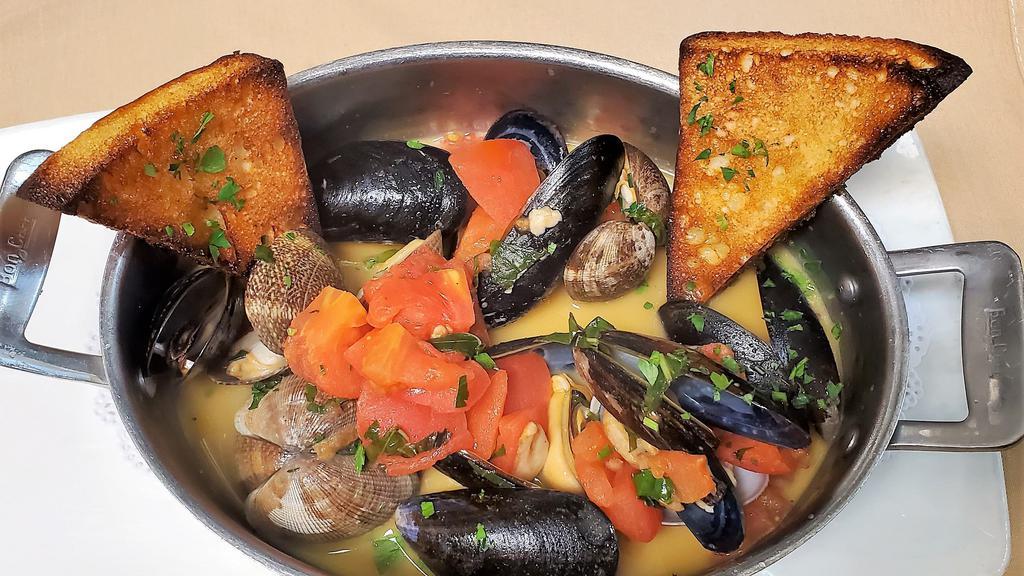 Brodetto Di Cozze E Vongole · Mussels and manila clams in a roasted garlic and chopped tomato white wine broth, served with toasted country bread.