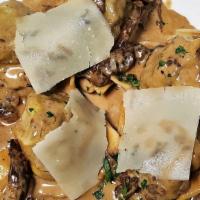 Cappellacci Di Manzo · Homemade hat-shaped pasta filled with braised prime short rib. Simmered in a porcini-pepperc...
