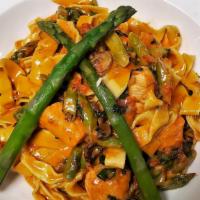Fettuccine Al Salmone · Fresh homemade pasta, king salmon, mushrooms, asparagus and sun-dried tomatoes, simmered in ...