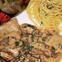Scaloppine Ai Funghi Porcini · Pan-seared, milk-fed scaloppine of veal sautéed with fresh porcini mushrooms in a brandy cre...