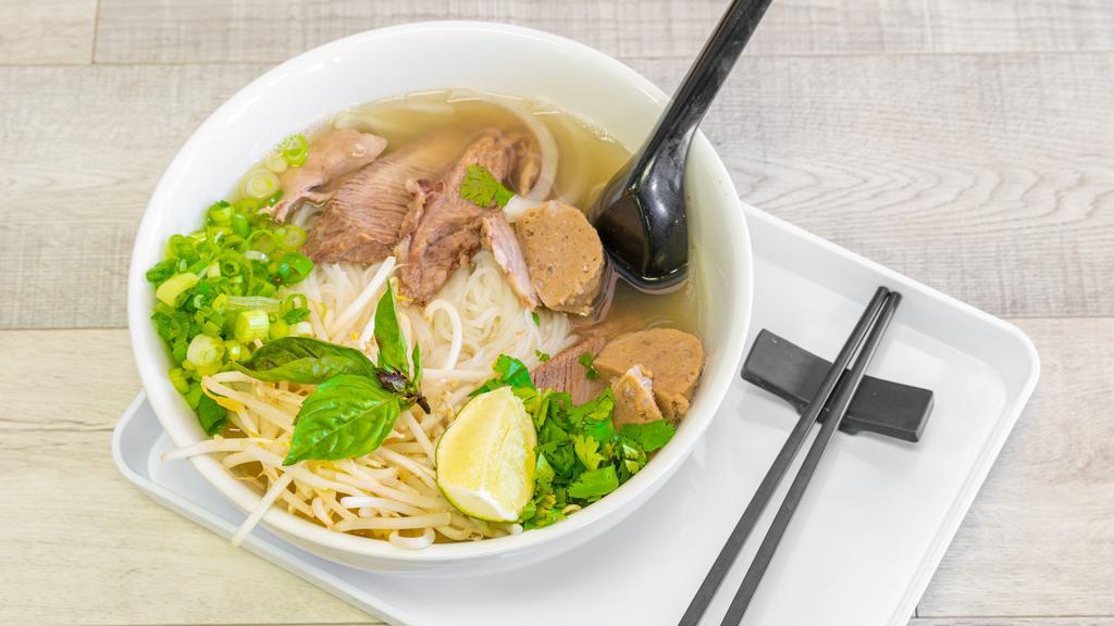 Meat Lover Pho · Beef broth, rice noodles, rare steak, meatballs (beef), brisket, bean sprout, lime, green onions, yellow onions, cilantro, and basil.