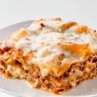Lasagna · Layers of pasta, ricotta, mozzarella, ground beef, and tomato sauce baked in an oven and top...