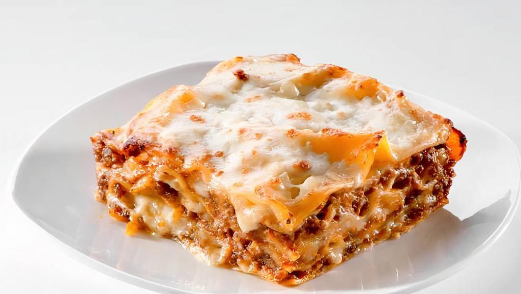 Lasagna · Layers of pasta, ricotta, mozzarella, ground beef, and tomato sauce baked in an oven and topped with parmesan.