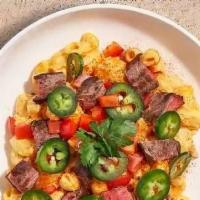 Steak  Chipotle  Mac · Steak, chipotle cheese sauce, diced fresh tomatoes, and jalapenos cooked in a blend of cream...