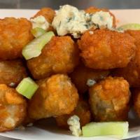 Buffalo Tots · Crispy tater tots, tossed with hot buffalo sauce, topped with celery and blue cheese.