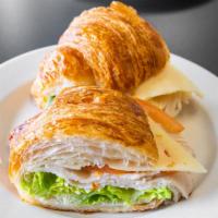 Inspecteur Clouseau · Mayo, tomato, cheese, black forest ham or turkey in croissant and lettuce.