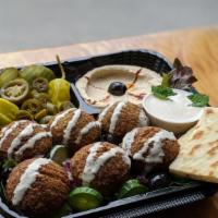 Falafel Plate · Vegetarian. Homemade ground chickpeas, parsley, cilantro and onions fried to perfection. Top...