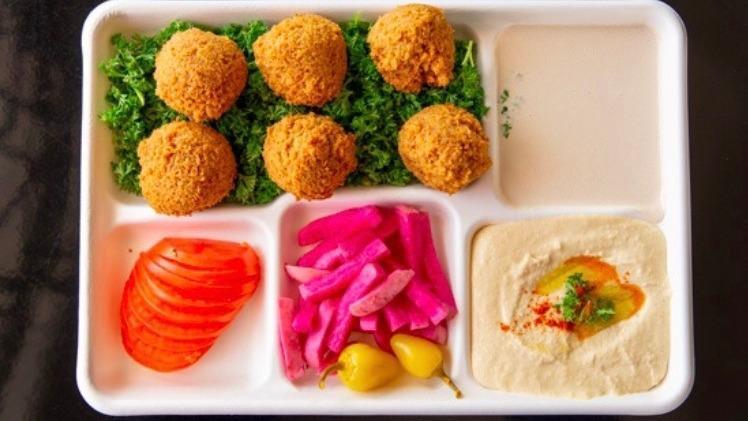 Falafel Plate · Vegan.  Six pieces falafel served with lettuce tomato, pepperoncini, turnip rose pickles, tahini sauce, hummus, two pieces of pita bread.