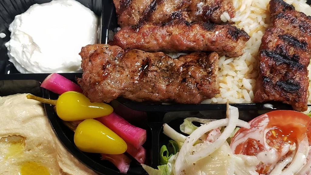 Lule Kabob Plate · Ground beef kabob served with french fries or rice, salad, hummus, garlic sauce, pickles and two pita bread.