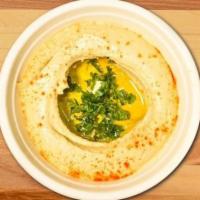 Hummus · Vegan. Garbanzo beans, fresh garlic and tahini (100% ground hulled sesame seeds) blended tog...