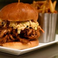 Pulled Pork Sandwich · House braised pork smothered with Sweet Baby Ray's®, topped with house made smoky chipotle s...