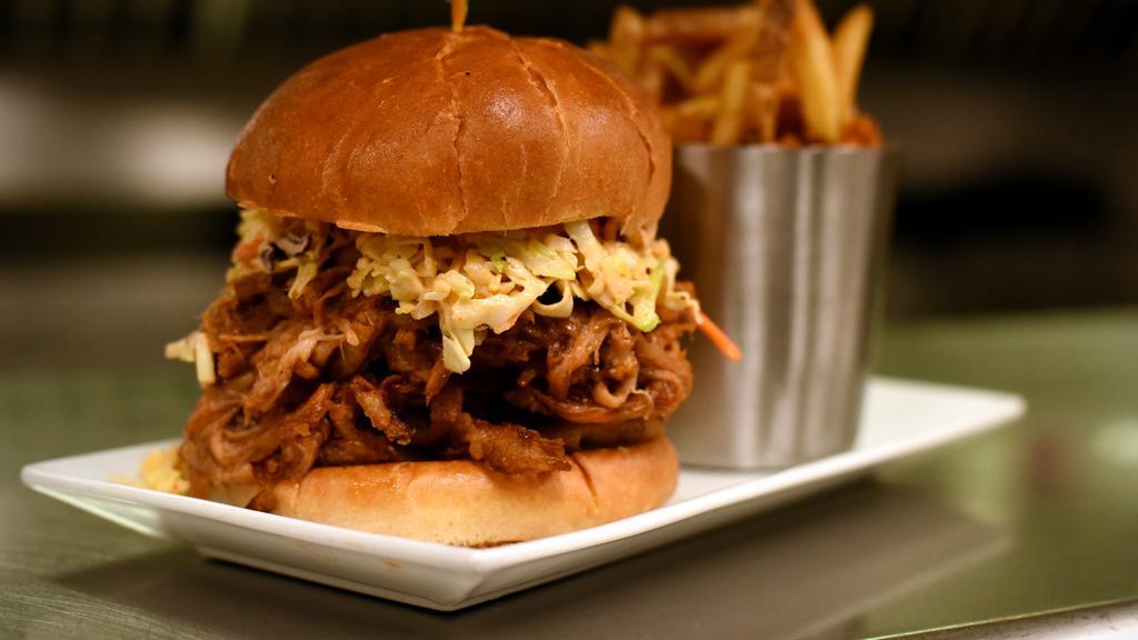 Pulled Pork Sandwich · House braised pork smothered with Sweet Baby Ray's®, topped with house made smoky chipotle slaw & crispy fried onions on a toasted bun.