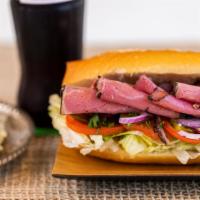 Pastrami Sandwich · Beef pastrami topped with lettuce, tomato, pickles, onions, parsley, and ranch sauce.