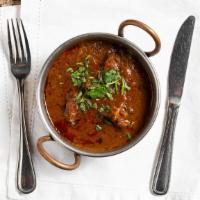 Goat Curry · Goat cooked in gravy and spices