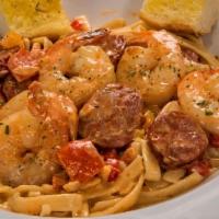 Voodoo Pasta · Sausage, large shrimp and diced peppers in white wine, tomato cream sauce over perfectly coo...