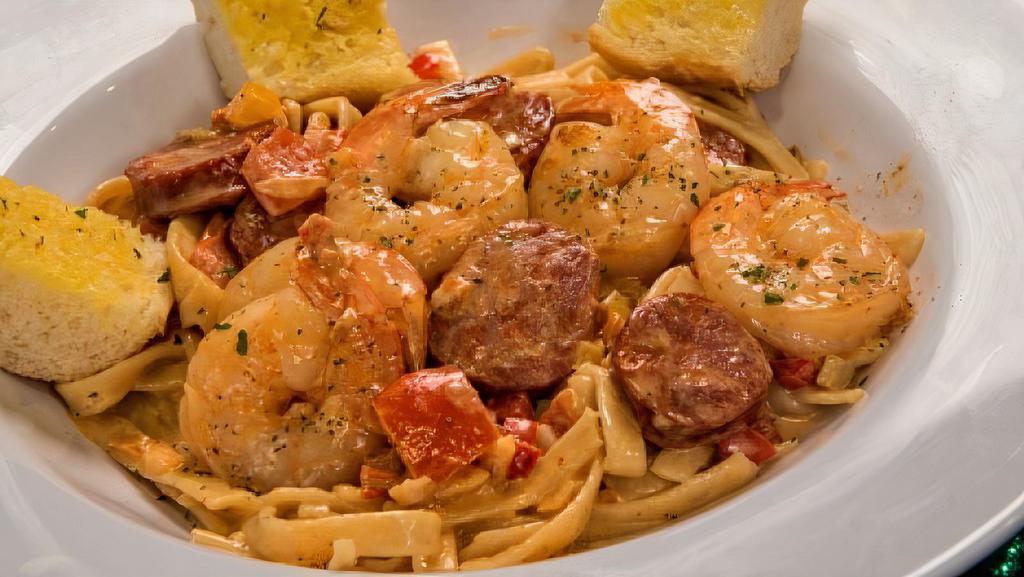 Voodoo Pasta · Andouille sausage, large shrimp, and diced red, yellow and orange bell peppers in a white wine tomato cream sauce over fettuccine. served with hot garlic French bread.