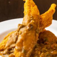 Cat-Touffée · 3 strips of Southern fried catfish glazed with crawfish étouffée over a bed of rice. served ...
