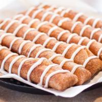 Cinnamon Sticks · Tender breadsticks with butter sugar and cinnamon and side of sweet icing.
