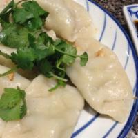 Steamed Dumplings · Steamed dumpling made with chicken, shrimp, crabmeat,
green onions and carrots served with s...
