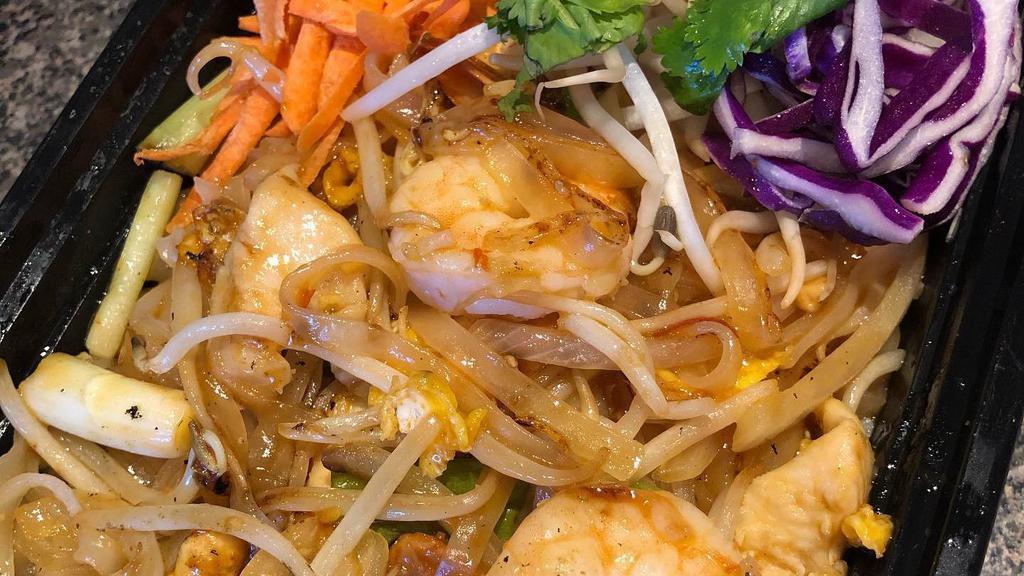 Pad Thai · Gluten-free. Stir-fried thin noodles with eggs, bean sprouts, green onions, ground peanuts and lime on the side with pad Thai sauce.