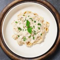 All About Alfredo (Fettuccine) · Fettuccine pasta cooked in creamy white sauce topped with parmesan.