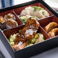 Seafood Bento · Salmon teriyaki, kazoku roll (3pc.), seafood gyoza, sunomono, & rice.