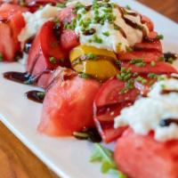 Heirloom Tomato And Watermelon Salad · Local heirloom tomatoes, burrata cheese, basil crystals