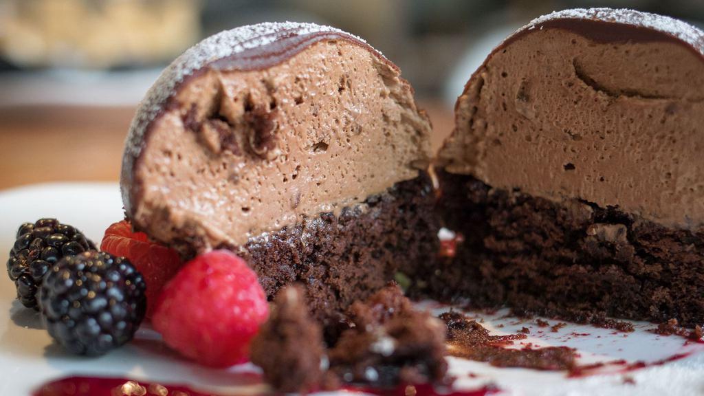 Chocolate Bombe · Chocolate brownie, chocolate mousse, chocolate ganache, berry purée.