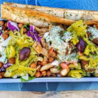 Vegan Doner Basket · Salad and fries topped with hummus, falafel, lemon-herb tahini, pepperoncinis, onion, green ...