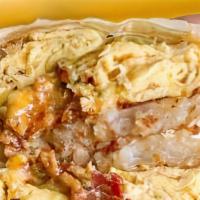 Breakfast Burrito · Includes scrambled eggs, cheese, and hash brown.