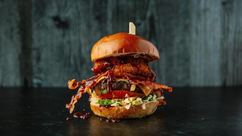 Brooksy Bbq · Applewood Bacon, Gourmet onion rings, Grilled onions, Lettuce, Tomato, Colby Jack Cheese, BBQ sauce.