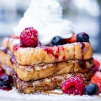 Stuffed French Toast · Brioche bread, maple-butter syrup, whipped cream, cream cheese, fresh berries, caramel sauce.