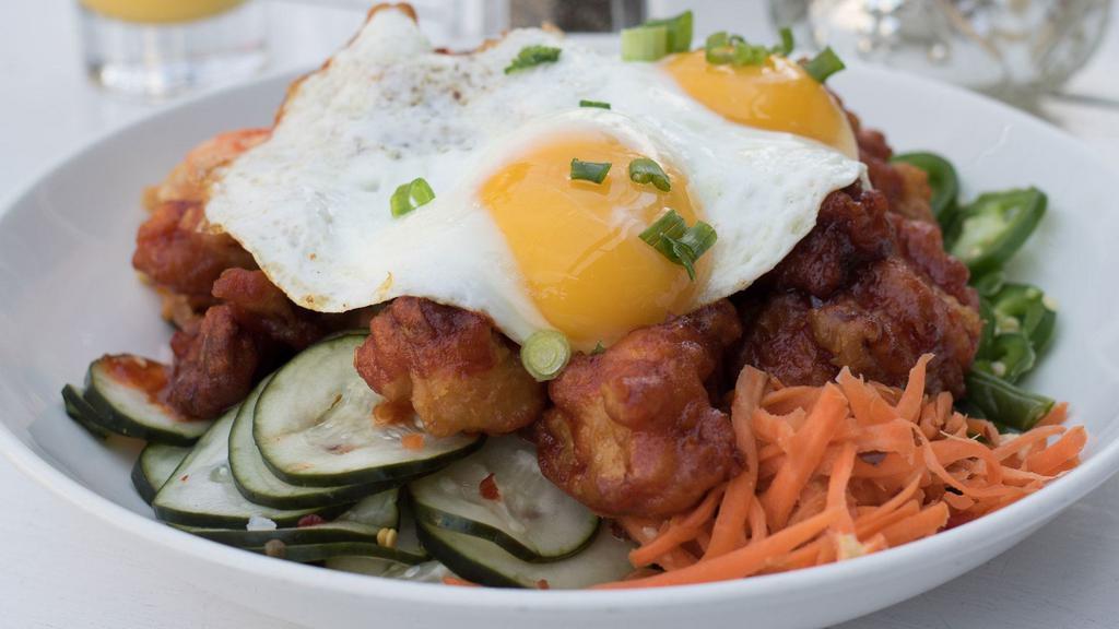 Korean Fried Chicken · Spicy pickled vegetables, sunny side up eggs, kim chee, jalapeños, white rice.