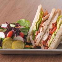 Grilled Chicken Club Sandwich · Choice of bread, topped with lettuce, tomato, bacon, avocado, with side salad & pickles.