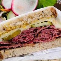 Pastrami Melt Combo · Slow smoked pastrami, melted Swiss cheese, pickles on rye bread. Comes with chips and a drink.