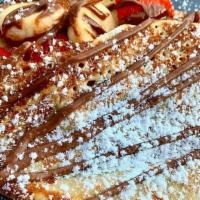 Crepes · Freshly made Crepes, serve with strawberries and banana with nutella and sugar powder.