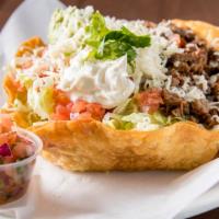 Tostada Salad · Chicken or pork in a large crisp tortilla shell with lettuce, beans, cheese, sour cream, fre...