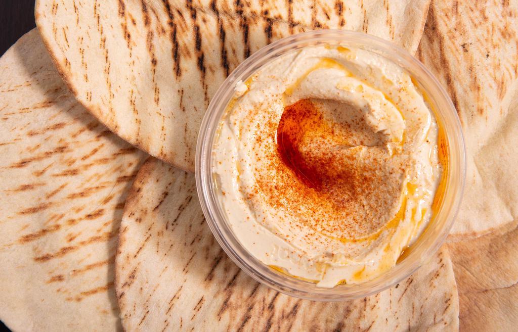 Hummus · Our signature, smooth and creamy chickpea hummus made with tahini, fresh garlic and lemon juice. Served with fresh pita.