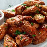 Spicy Chicken Wings · Fresh chicken wings smothered in a spicy house marinade with a side of creamy ranch dip.